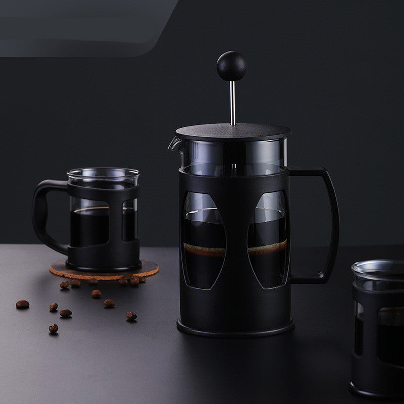 Manual coffee press French press brewer on a kitchen counter
Close-up of plunger and fine metal mesh filter in coffee press
French press pouring freshly brewed coffee into a mug
Disassembled coffee press showing carafe, lid, and filter
