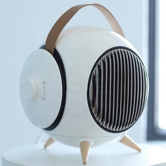 Household mini heater with adjustable (movable) air outlet on a desk

Compact portable space heater front view with direction louvres

Small household heater directing warm airflow in a home office

Portable mini fan heater placed on bedside table