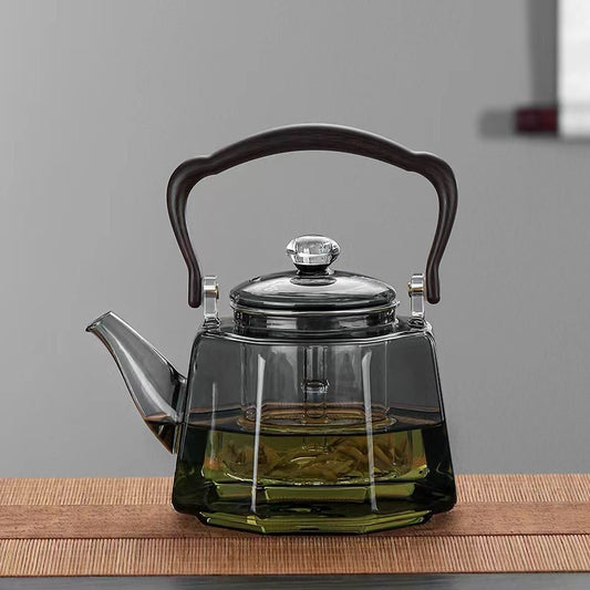 Large capacity clear glass teapot kettle on a table

Easy-pour spout on family-size glass teapot

Transparent glass teapot showing tea color while brewing

Serving tea from a large glass kettle into cups